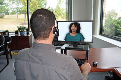 student talking to a virtual role-player on a screen